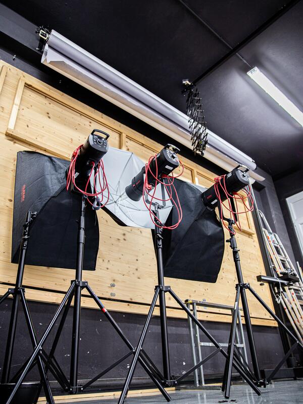 Fotostudio, Beleuchtungen mit Schirmen vor einer Holzwand
